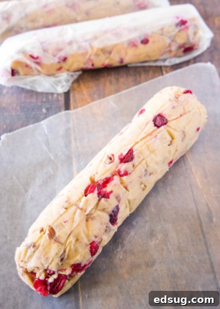 rolled log of icebox cookies dough, ready for chilling in wax paper