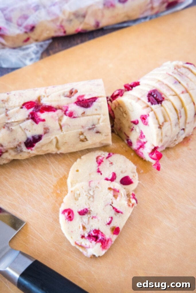 sliced icebox cookie dough pieces on a cutting board, ready for the oven