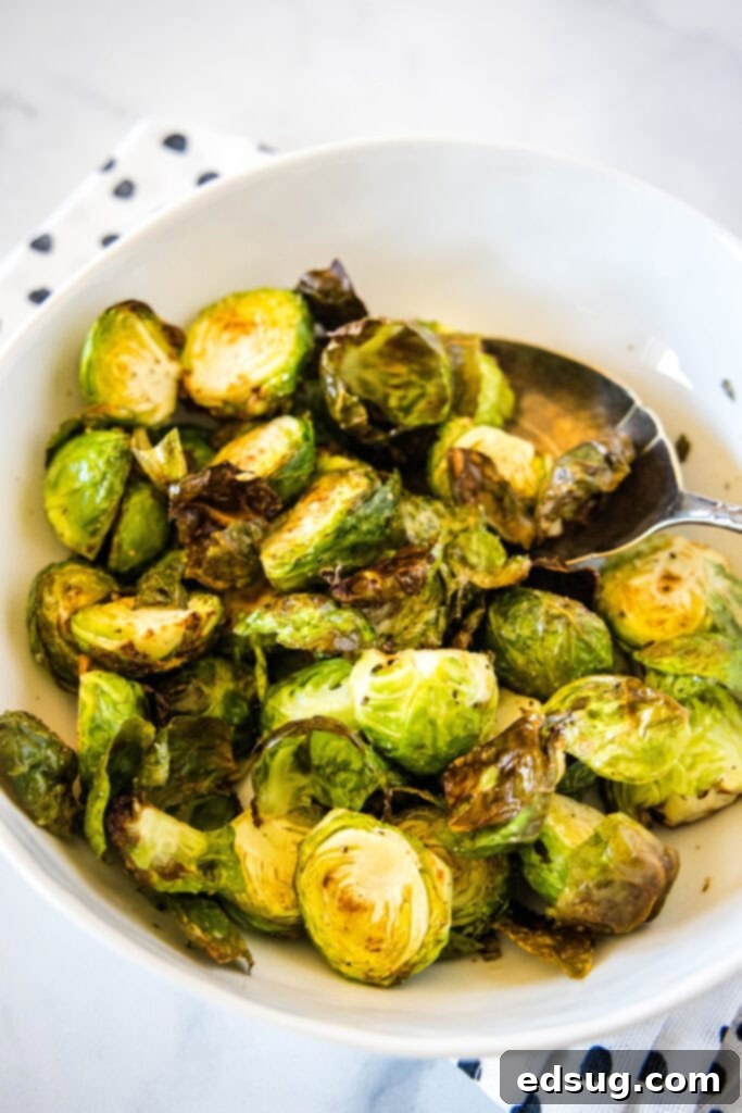 Golden Crispy Air Fryer Brussels Sprouts 6 Crispy Brussels sprouts served in a white bowl, ready to eat