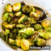 Golden Crispy Air Fryer Brussels Sprouts 8 cropped in close of up brussel sprouts in a white bowl