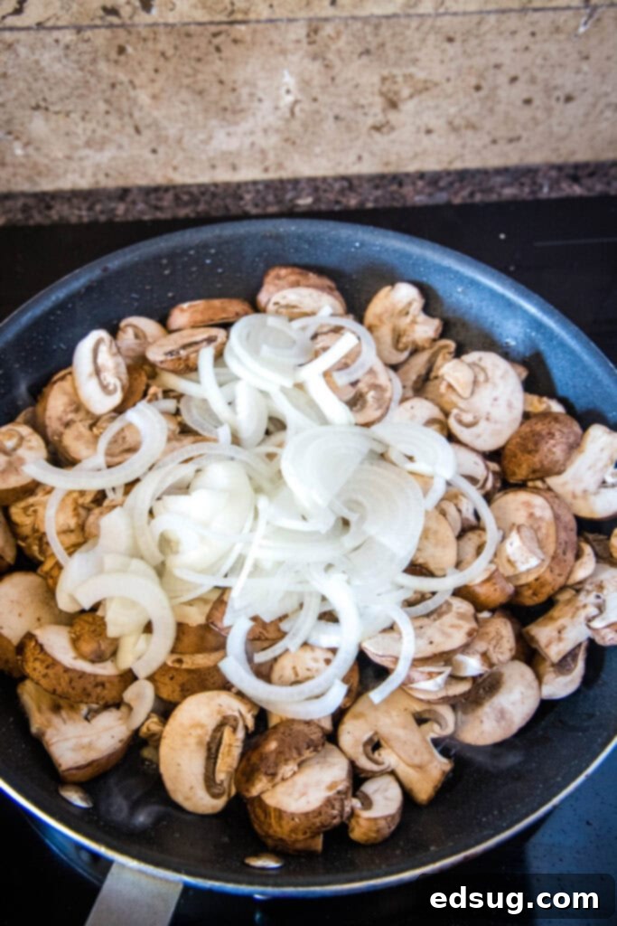 Bobby Flay Ultimate Salisbury Steak 4 Sautéing sliced mushrooms and onions in a large skillet, building the gravy base