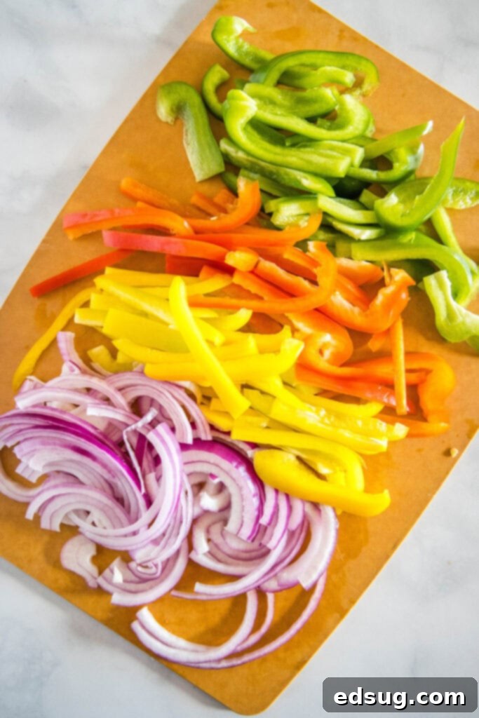 bell peppers and onions on a cutting board