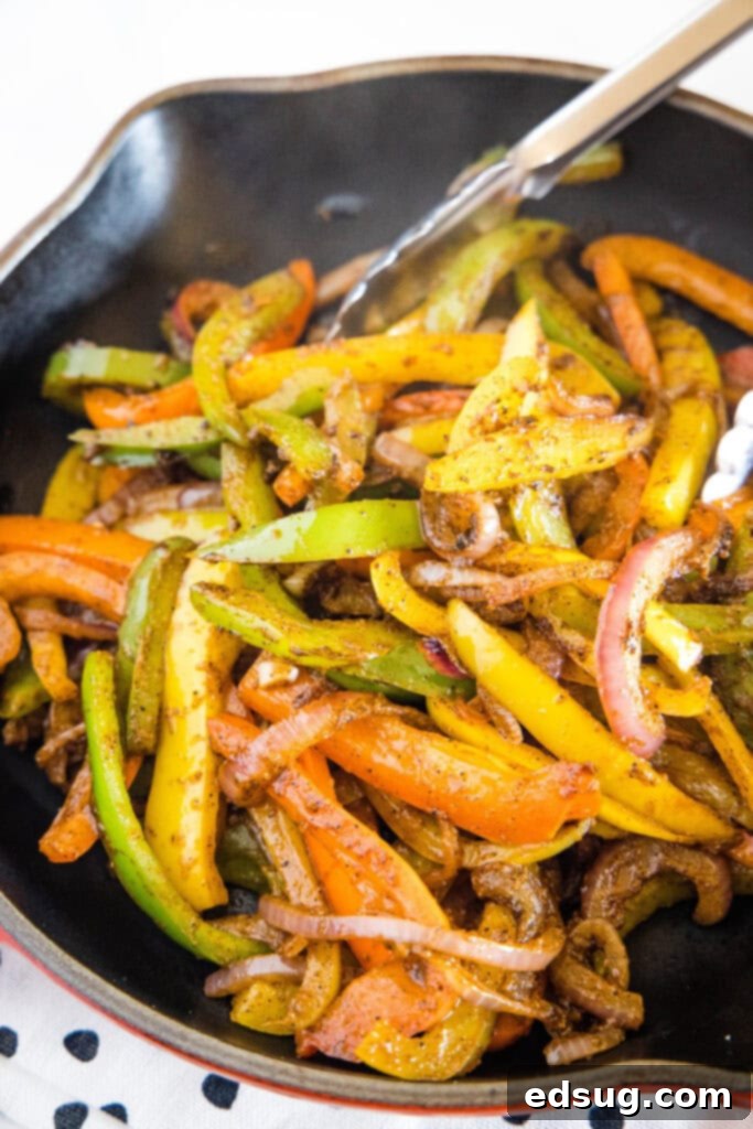 cooked bell peppers and onions in a skillet