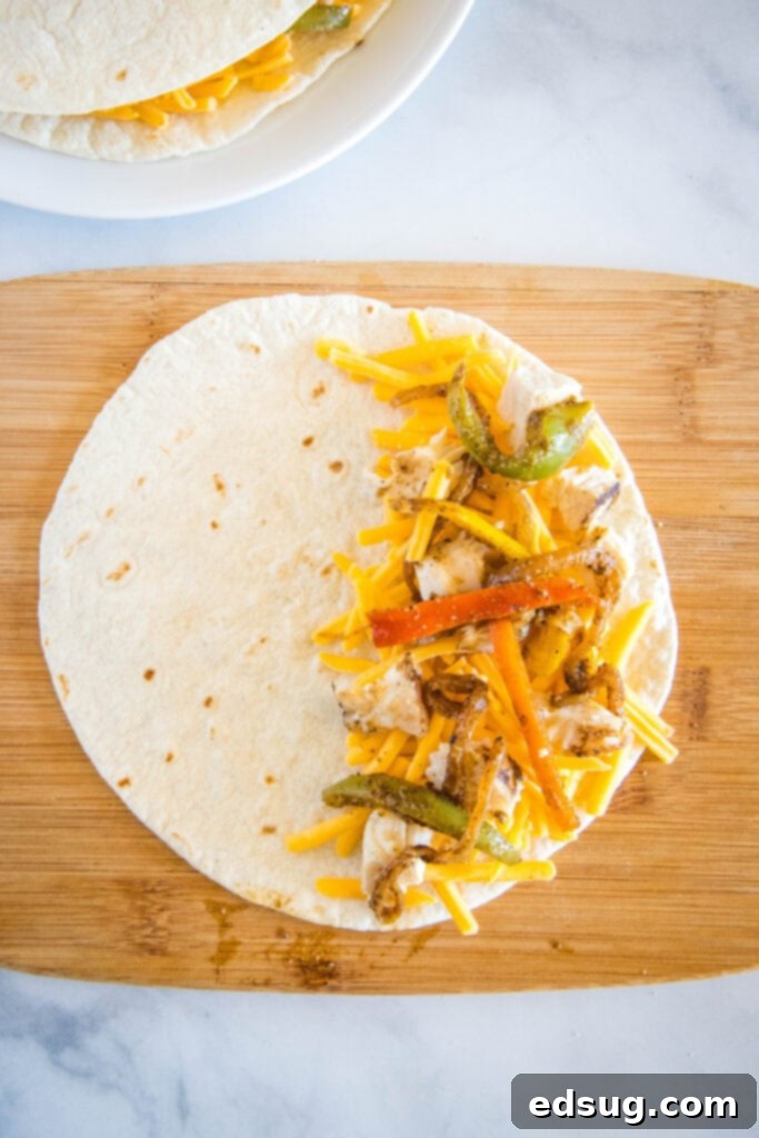 A cook carefully arranging various delicious fillings, including shredded chicken and cheese, onto a tortilla before folding it in half, ready to be transformed into a crispy quesadilla.