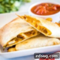 Close-up of perfectly cooked Air Fryer Quesadillas, golden and crispy, showcasing the delicious melted cheese and filling within.