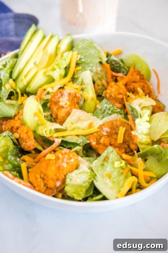 Kickin' Buffalo Chicken Salad 5 A perfectly tossed Buffalo Chicken Salad in a white bowl, ready to be served.