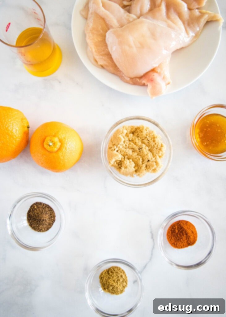 Sticky Orange Chicken 3 A collection of fresh ingredients laid out, including orange juice, honey, apple cider vinegar, and various spices, ready for making the orange glaze.
