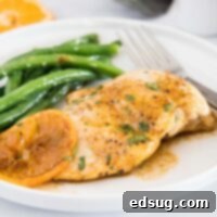 Sticky Orange Chicken 6 close up chicken breast with orange glaze on white plate