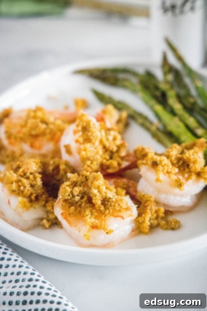 Golden Crispy Shrimp 2 crispy baked shrimp on a plate with asparagus