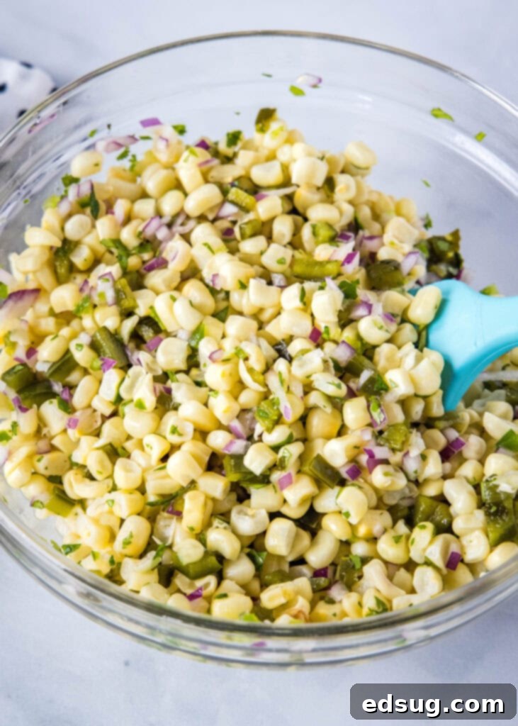 mixing together corn salsa ingredients