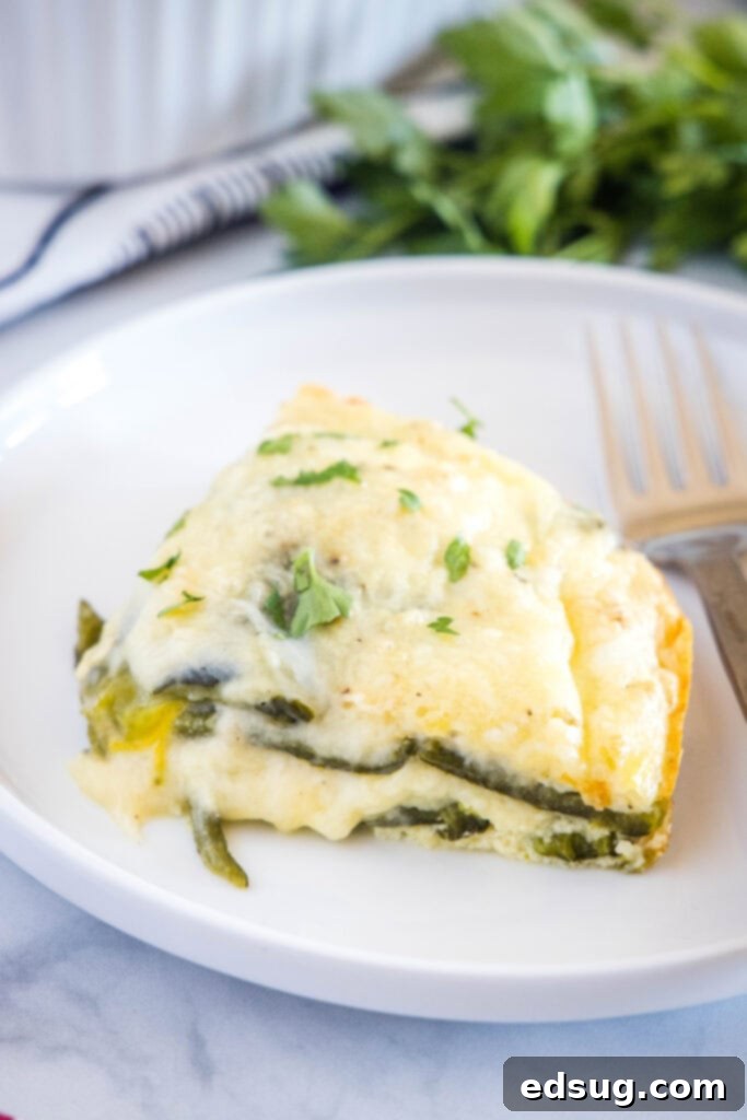 chili relleno casserole slice on a white plate with a fork