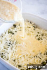 pouring egg mixture over the casserole