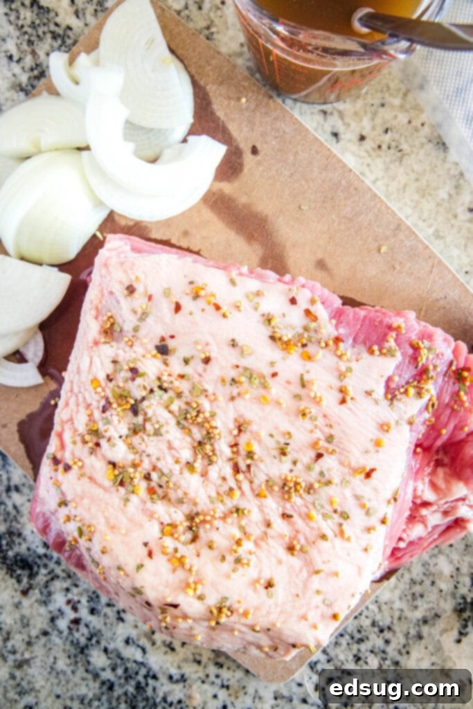 looking down on cutting board with corned beef rubbed with spices