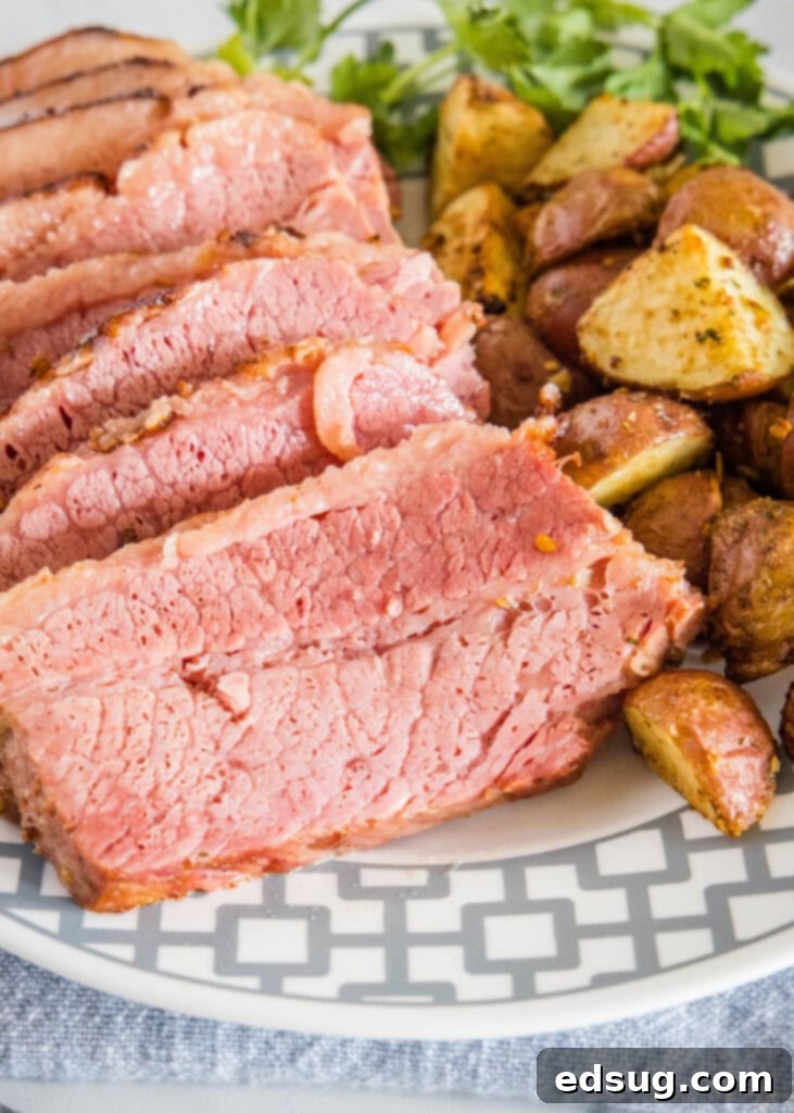 sliced corn beef on a plate with potatoes