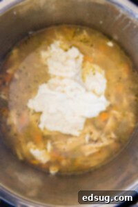 Hearty Instant Pot Chicken Wild Rice Soup 10 adding roux to instant pot with soup