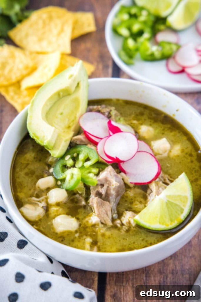 Effortless Instant Pot Pozole 2 bowl of pozole topped with radishes, avocado and lime, showcasing a hearty Mexican soup