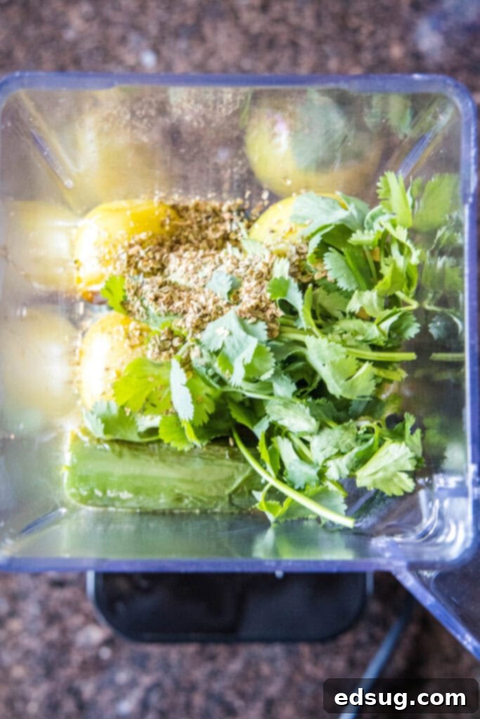 Effortless Instant Pot Pozole 4 salsa verde ingredients in blender, being pureed for a smooth texture