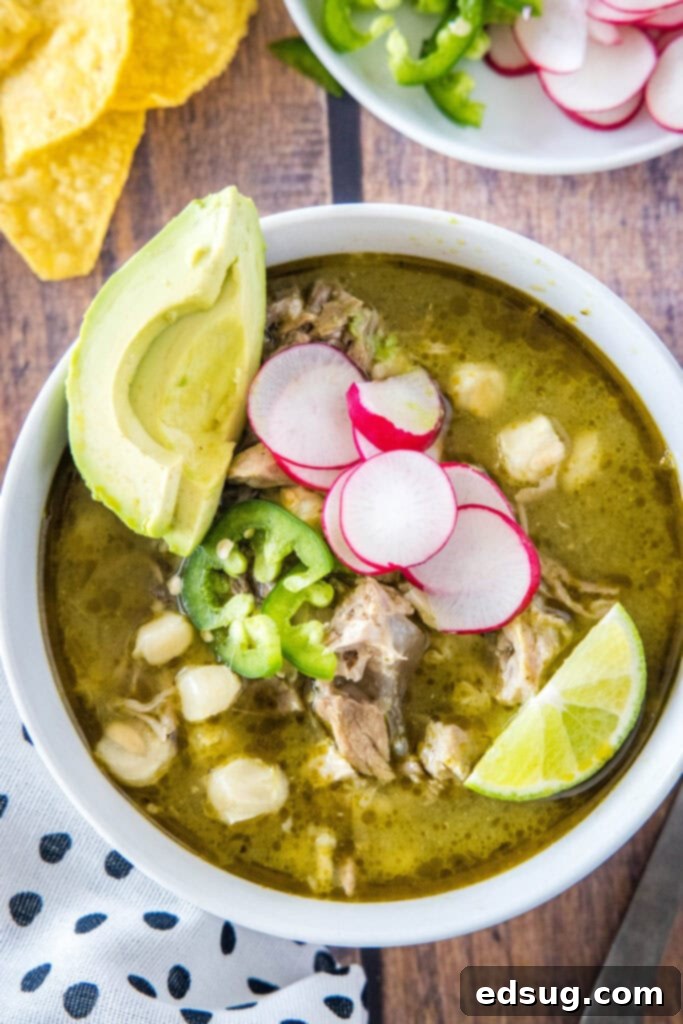 Effortless Instant Pot Pozole 6 looking down on a bowl of pozole soup, garnished with fresh toppings