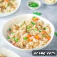 instant pot chicken and rice in a bowl with peas and carrots
