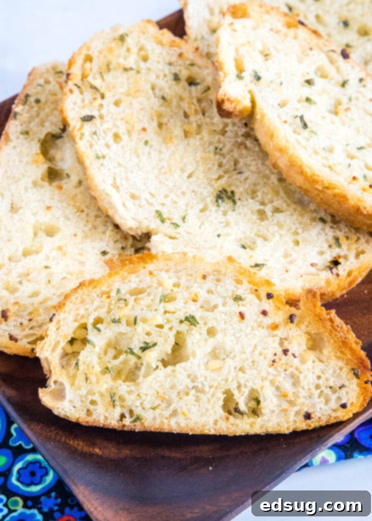Crispy Air Fryer Garlic Bread 4 crispy garlic bread on a wood plate