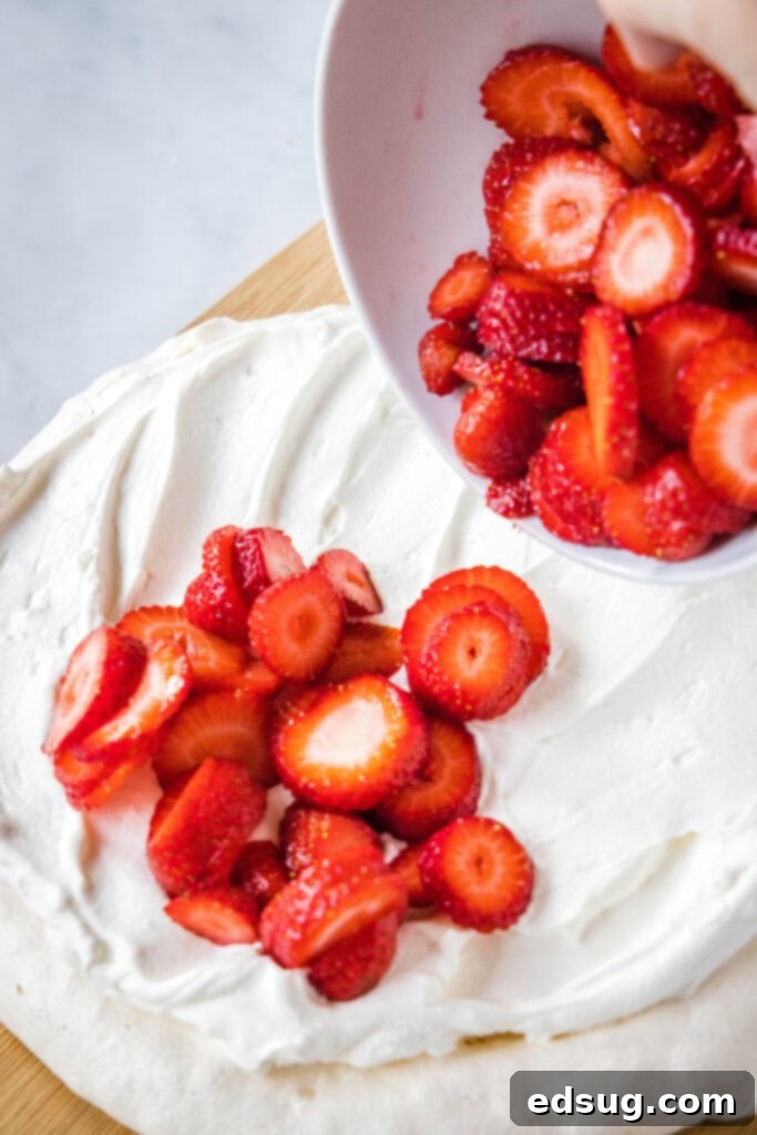 Perfect Pavlova 7 putting strawberries on a pavlova