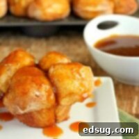 Caramel Glazed Pumpkin Monkey Bread Muffins 2 Pumpkin Caramel Monkey Bread Muffins with a rich, glossy caramel drizzle.