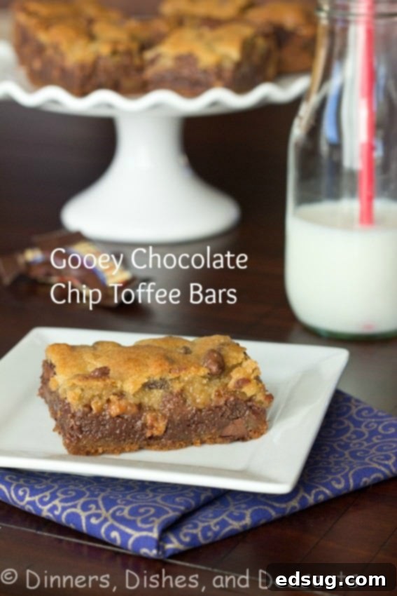 Gooey Chocolate Chip Toffee Bars stacked on a white plate, showcasing the distinct layers of cookie, fudge, and toffee