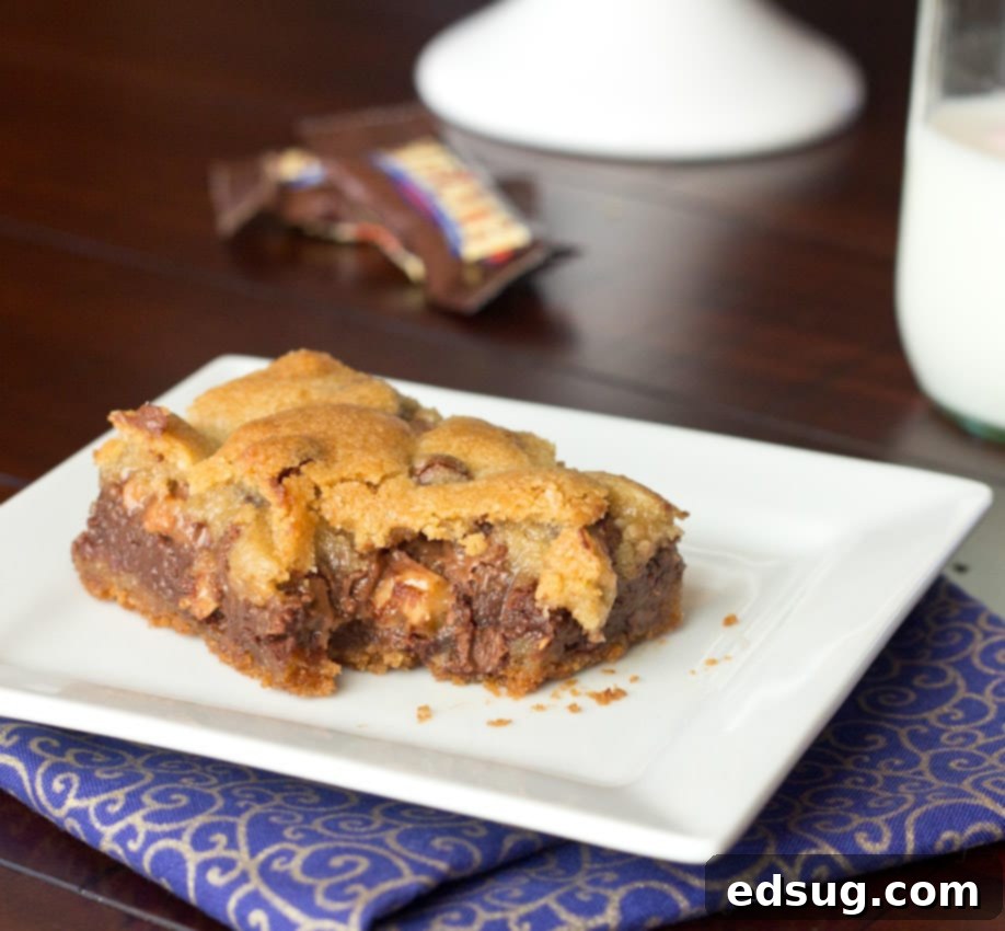 Close-up of a freshly cut Gooey Chocolate Toffee Bar, highlighting the smooth chocolate fudge and crunchy Heath toffee bits