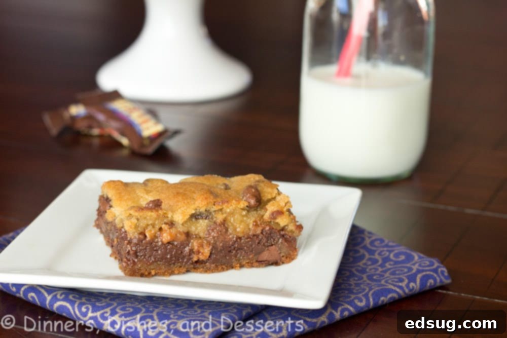 Batch of freshly baked Gooey Chocolate Toffee Bars cooling in a parchment-lined pan before slicing