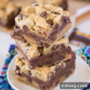Stacked Toffee Chocolate Chip Bars on a white plate, showing golden top and gooey layers
