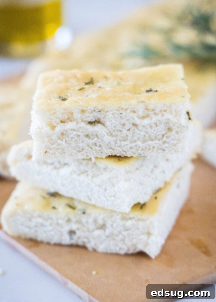 Aromatic Rosemary Focaccia 2 stacked focaccia bread on a cutting board
