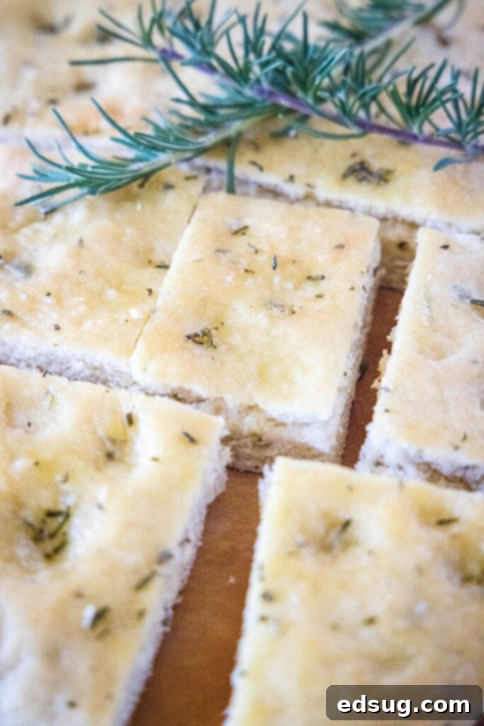 Aromatic Rosemary Focaccia 3 sliced focaccia bread on a cutting board