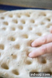 Aromatic Rosemary Focaccia 10 pressing dimples into focaccia bread