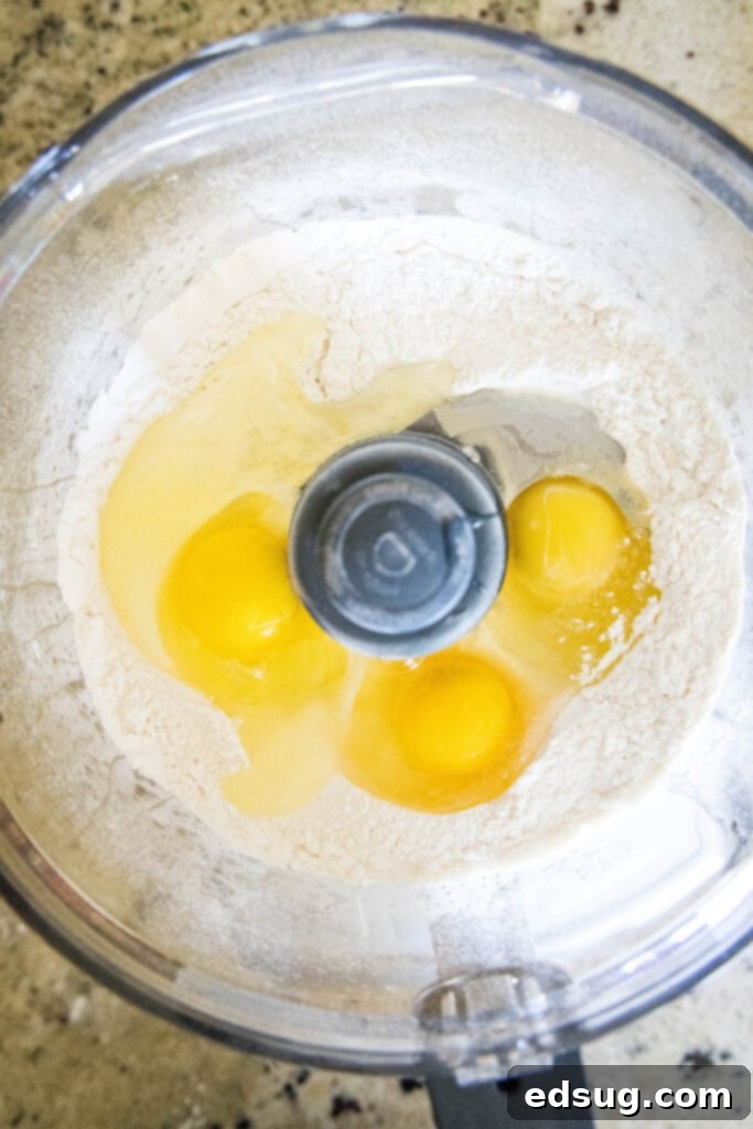 Handcrafted Ravioli Delights 3 pasta dough ingredients in food processor, ready to be mixed