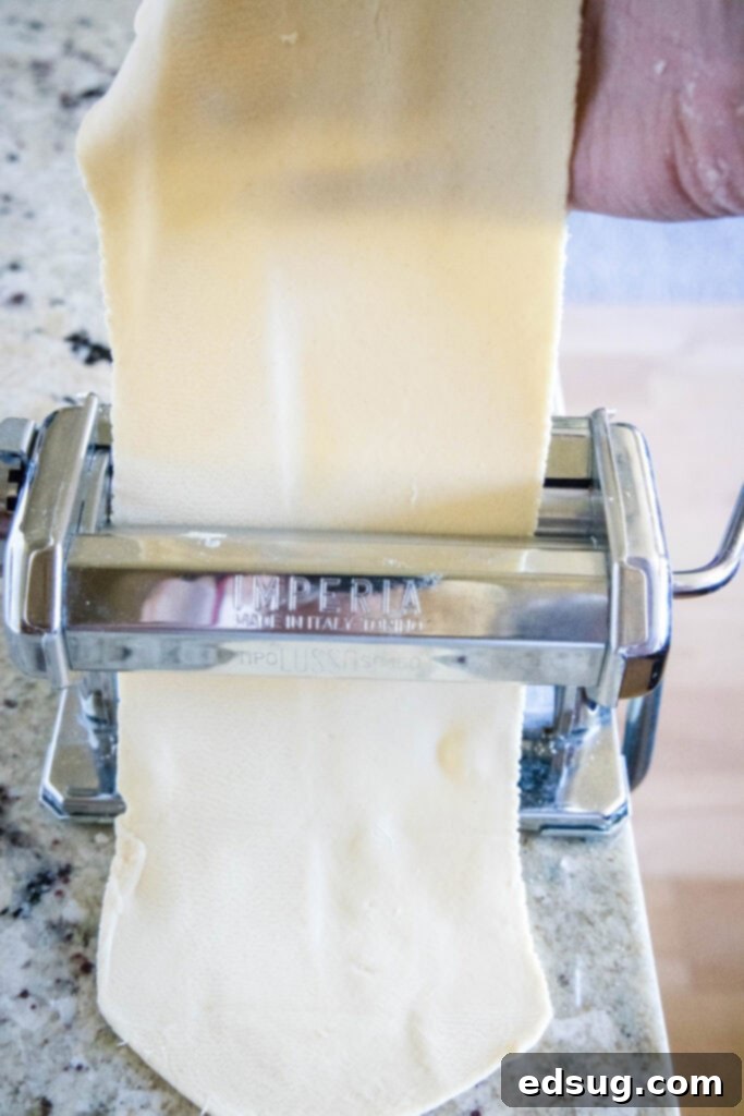 Handcrafted Ravioli Delights 5 rolling homemade pasta dough through a pasta machine