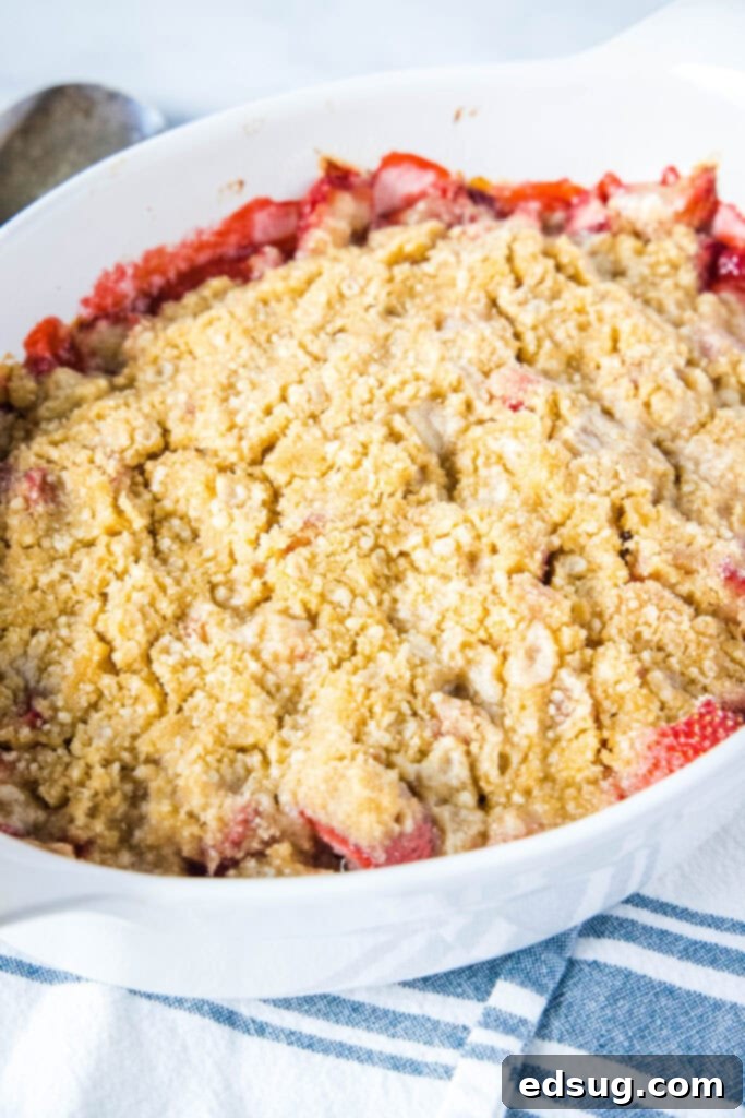 Irresistible Strawberry Crumble 5 Close-up of golden brown, crisp crumble topping on a freshly baked strawberry crumble, showing its delicious texture.