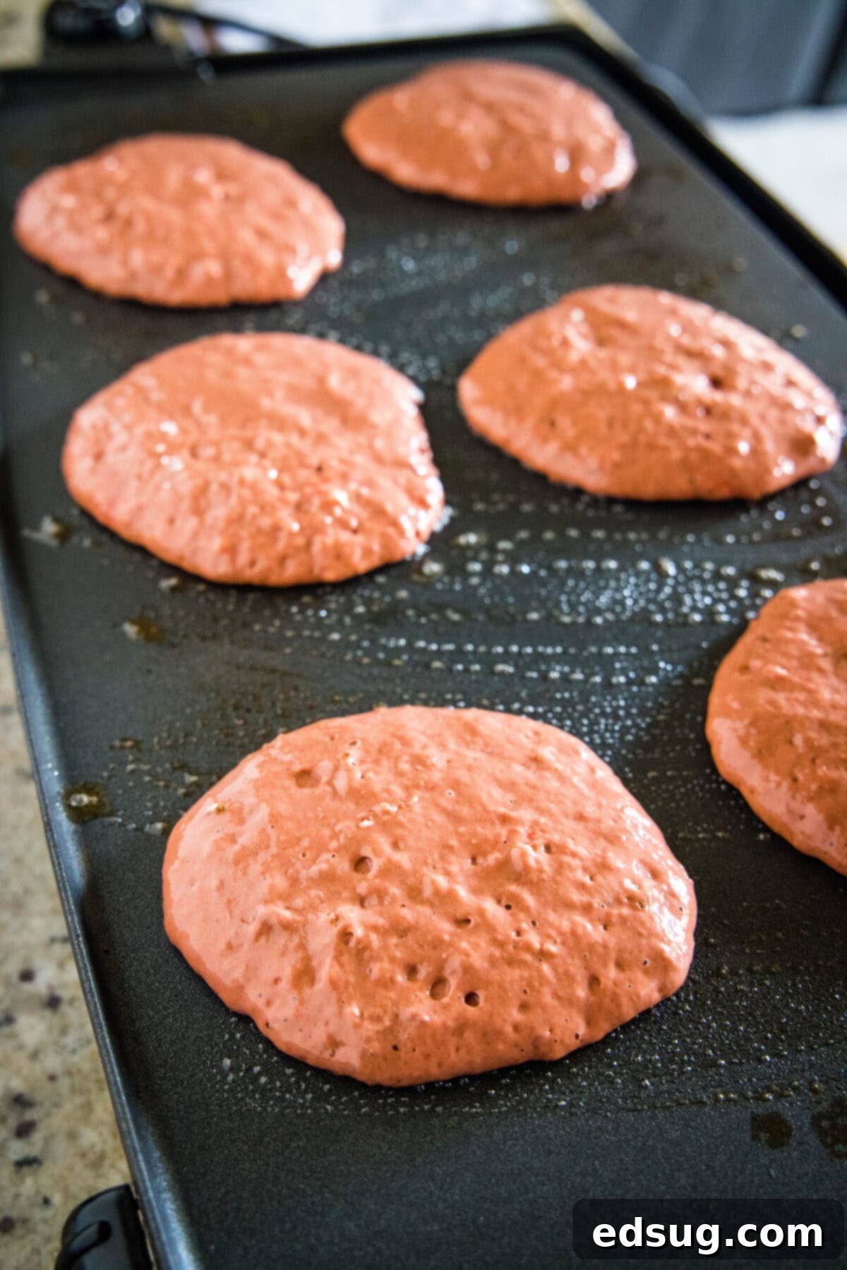 Red Velvet Pancakes | @dinnersdishesdessert red velvet pancakes on a griddle