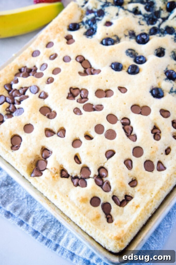 Sheet pan pancakes in a baking pan, ready for toppings