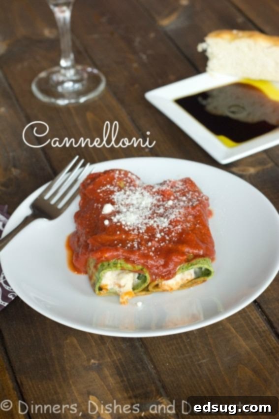 Delicious cannelloni with vibrant spinach pasta on a white plate, garnished with fresh herbs and a rich marinara sauce.