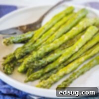 cropped image of asparagus close up on a white plate