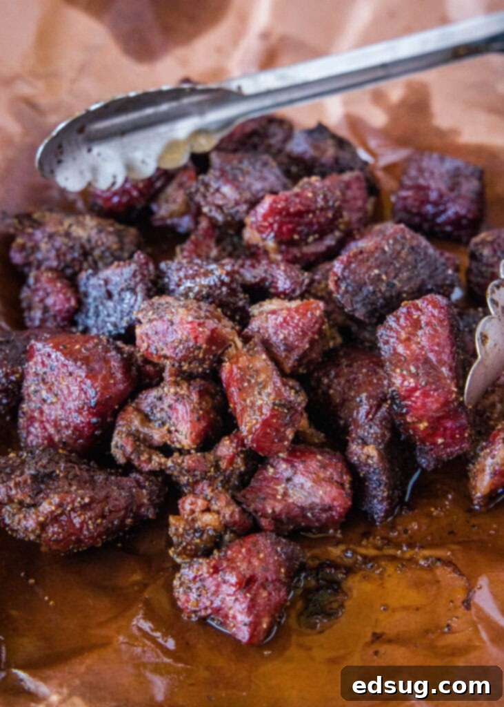 Burnt Ends on a Budget 2 Smoked chuck roast burnt ends on butcher paper, showcasing their rich color and juicy texture