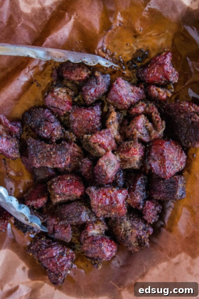 Burnt Ends on a Budget 6 Close up of cooked poor man's burnt ends, glistening with sauce, on butcher paper