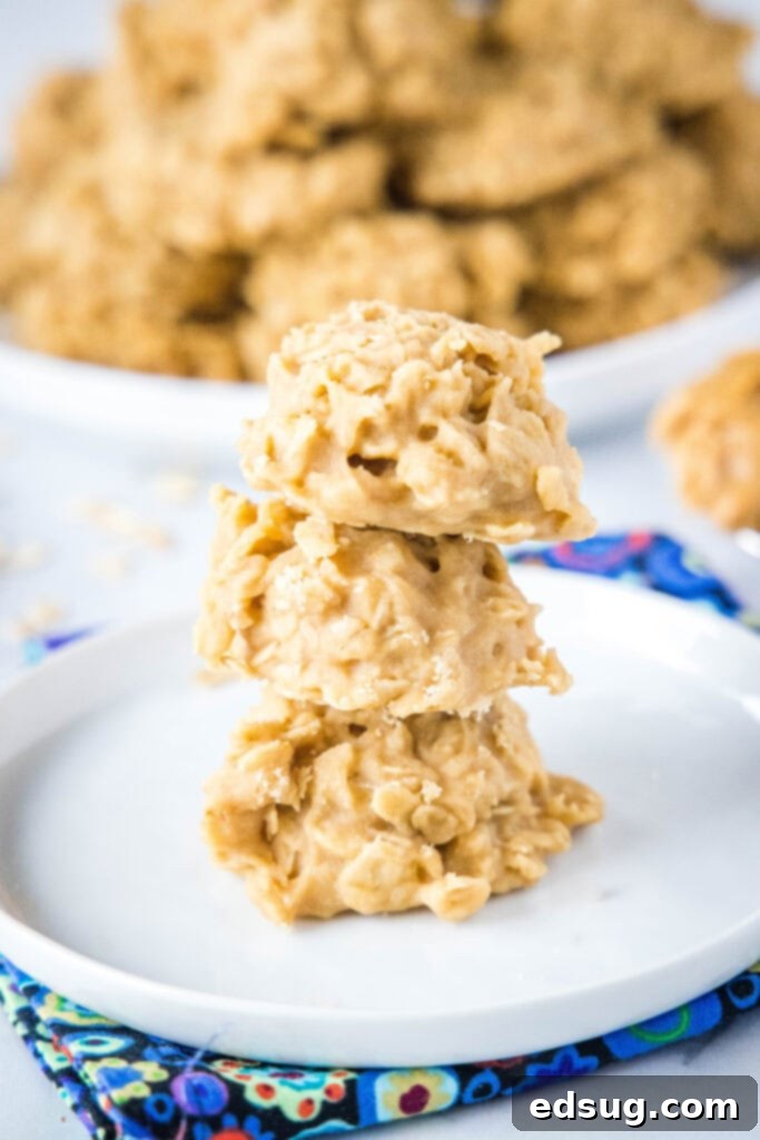 Stacked no-bake peanut butter oatmeal cookies on a white plate ready to be enjoyed