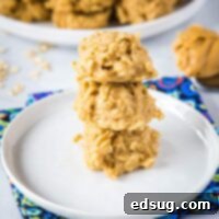 square image of peanut butter cookies close up stacked on white plate