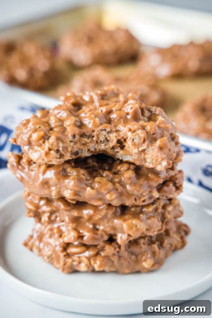 stacked star crunch cookies on a white plate with a bite missing from the top tone