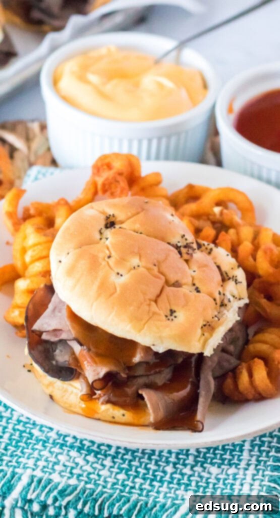 plate with roast beef sandwich and curly fries