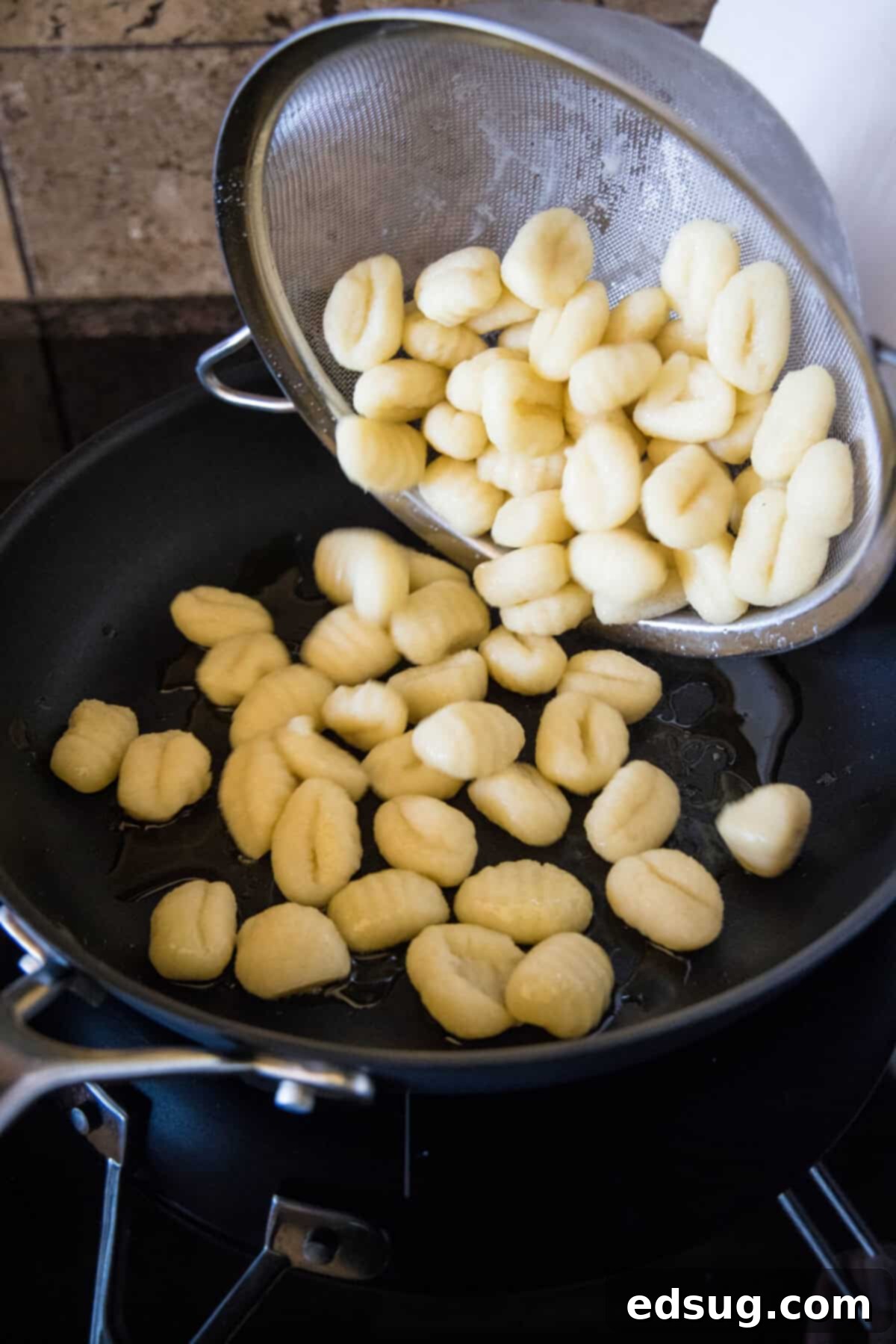 Make this quick weeknight brown butter gnocchi tossed in a rich, nutty browned butter sauce with sage. It's ready in 20 minutes! Gnocchi being added to a hot skillet with olive oil, ready for pan-frying to a golden crisp.