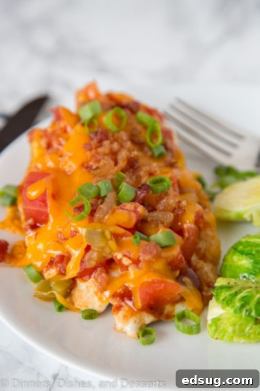 Loaded Monterey Chicken 4 A close up of a plate of Monterey chicken with a side of green beans, garnished with green onions