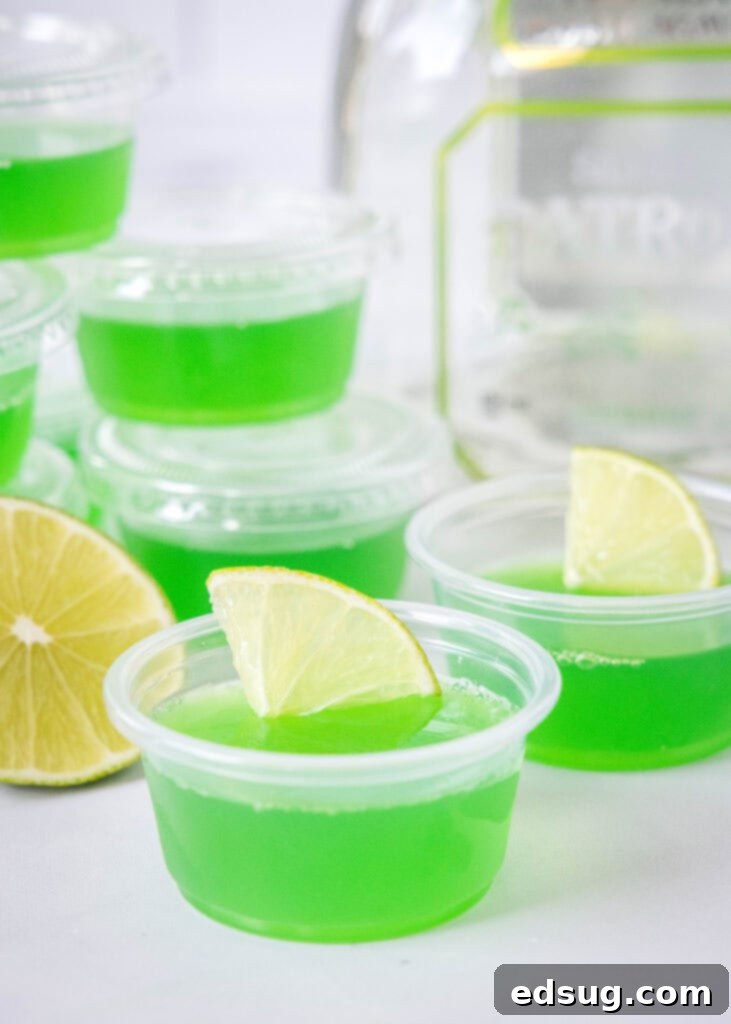 Tequila Lime Jiggle Shots 2 Margarita flavored jello shots garnished with a slice of lime, arranged attractively for a party