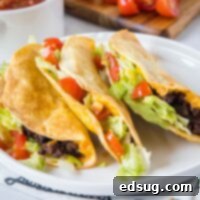 Crispy Air Fryer Tacos with fresh toppings arranged on a white plate, showcasing their perfect golden shells.